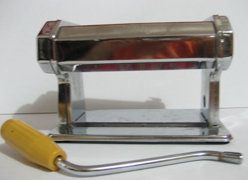 Using a pasta machine to flatten the polymer clay
