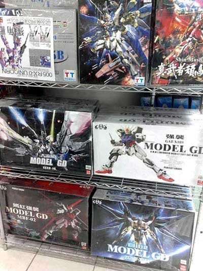 Bootleg Gundams For Sale stacked in a cabinet